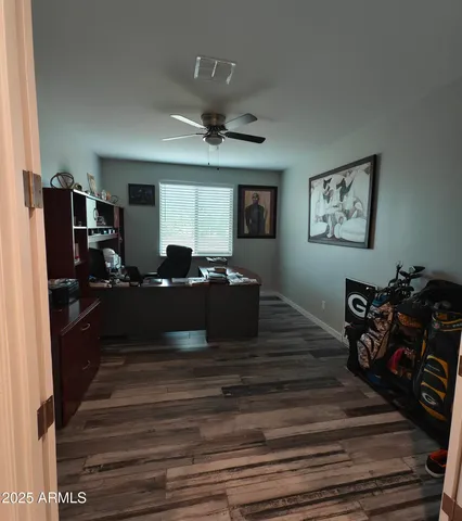 a bed room with furniture and paintings on the wall