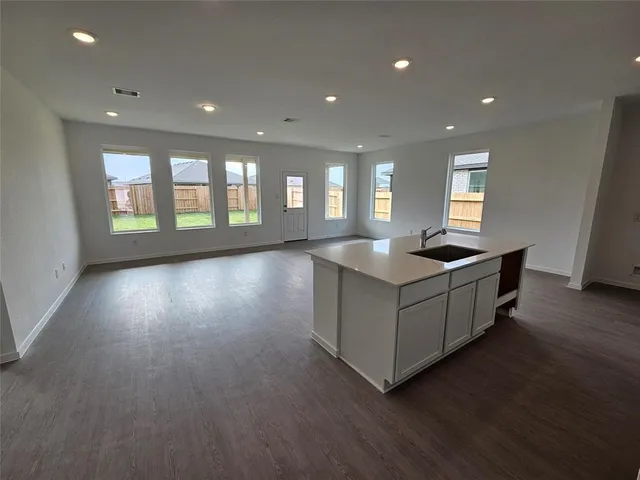a view of kitchen with cabinets and wooden floor