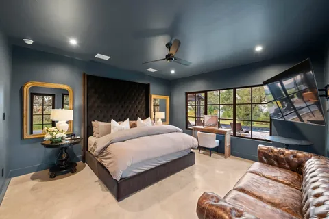 a bedroom with a large bed and a large window