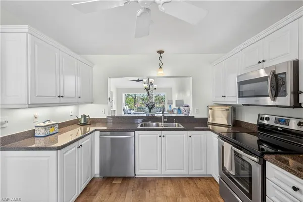 a kitchen with a sink stove and microwave