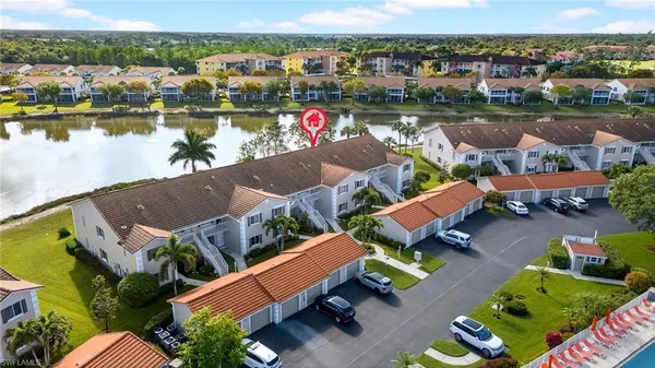 an aerial view of a house with outdoor space and lake view
