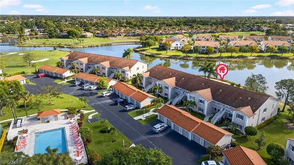 an aerial view of residential houses with outdoor space and river