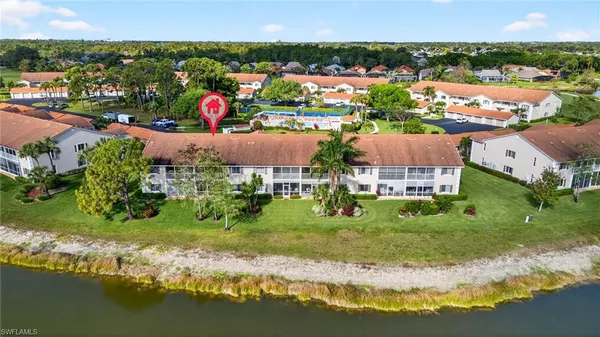 an aerial view of residential houses with outdoor space and lake view