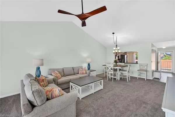 a living room with furniture and a ceiling fan