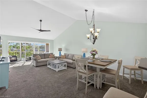 a view of a dining room with furniture wooden floor and a chandelier