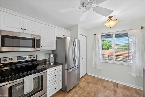 a kitchen with stainless steel appliances a stove a microwave and cabinets