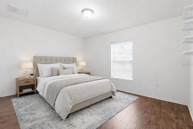 a bedroom with a bed and a window