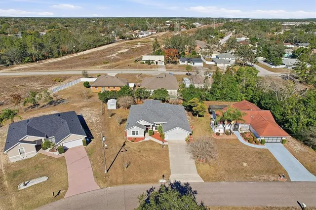 an aerial view of residential houses with outdoor space