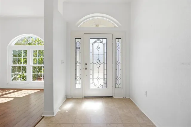 a view of an entryway with wooden floor and a window