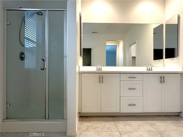 a bathroom with a granite countertop sink a toilet and shower