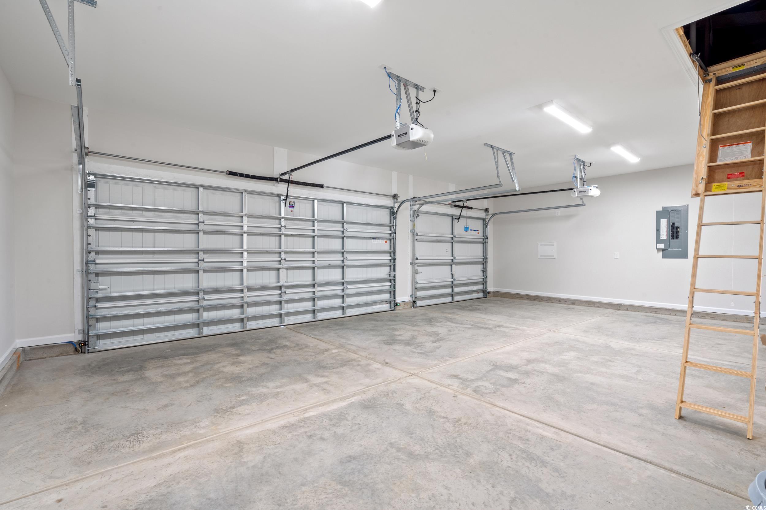 247 Stillbrook Drive Longs, SC 29568 - Photo 16 of 36 Garage featuring electric panel and a garage door opener