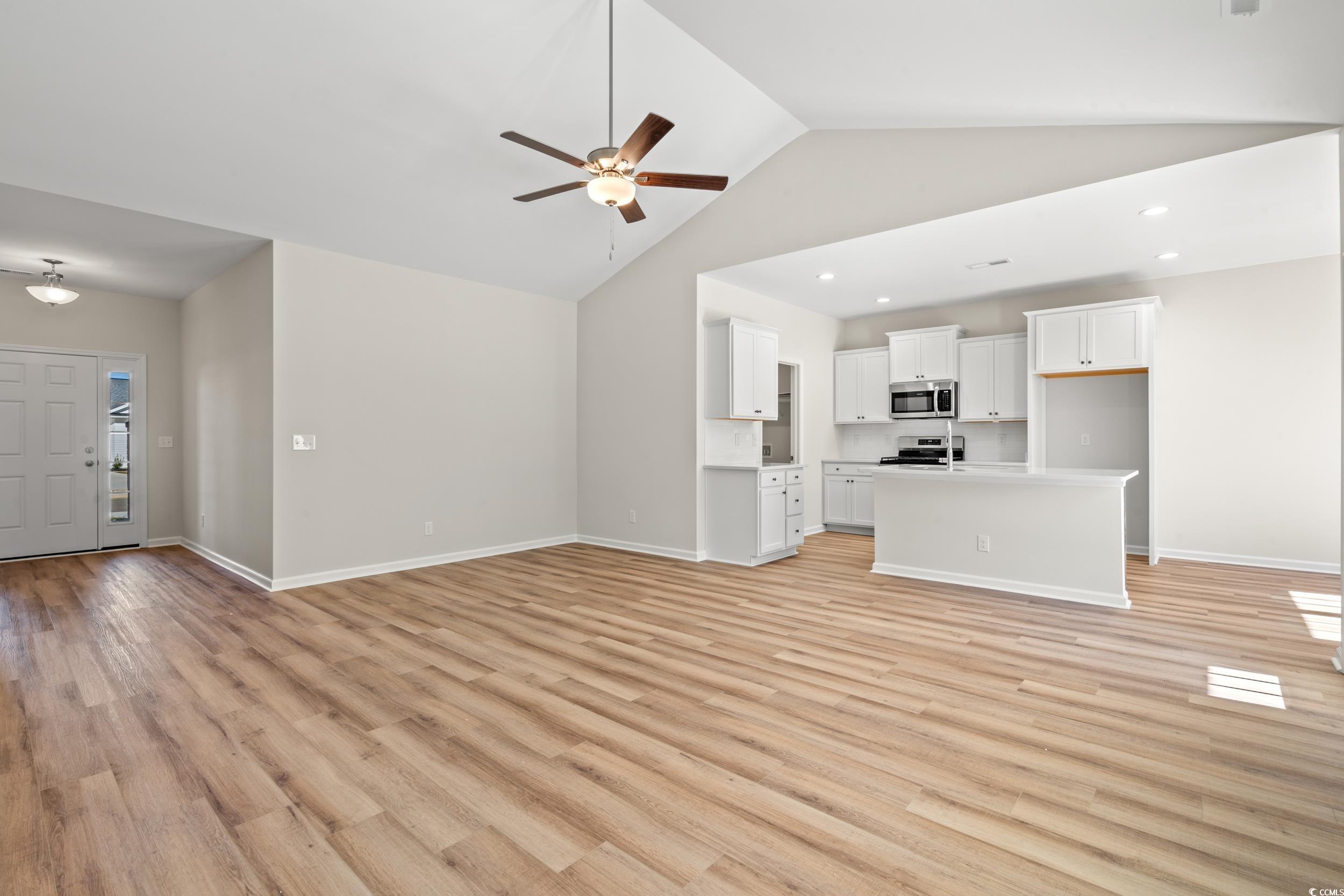 247 Stillbrook Drive Longs, SC 29568 - Photo 10 of 36 Unfurnished living room featuring light wood finished floors, a ceiling fan, high vaulted ceiling, and recessed lighting