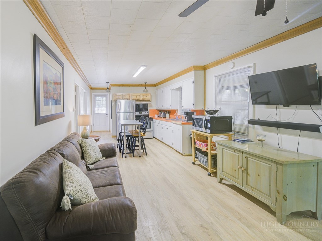 1471 Bamboo Road Boone, NC 28607 - Photo 4 of 19 a living room with furniture kitchen view and a flat screen tv