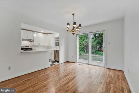 a view of a kitchen with wooden floor and a window