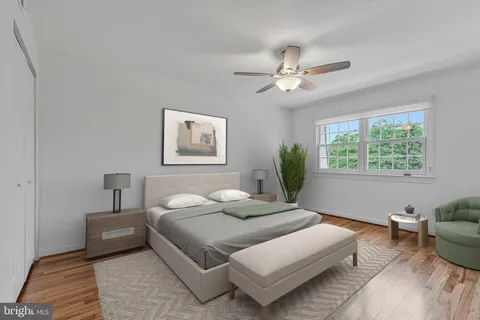a bedroom with a large bed couch and a window