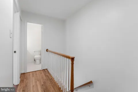 a bathroom with a granite countertop sink a toilet and a mirror