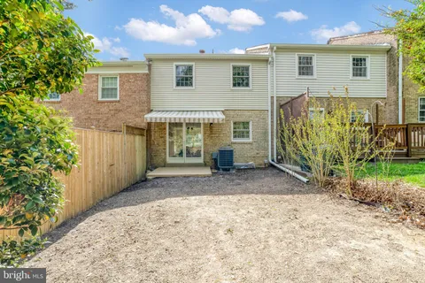 a backyard of a house with barbeque oven