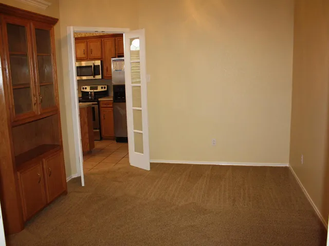 a view of a kitchen with refrigerator and cabinet