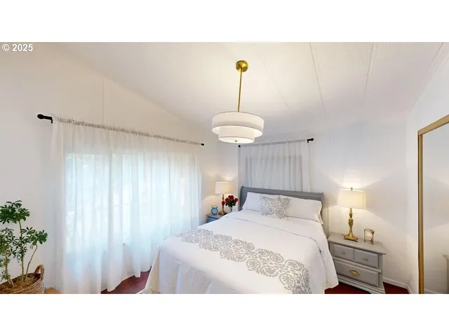 a living room with a bed and a chandelier