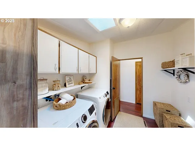 a en suite bathroom with a sink and a washer dryer