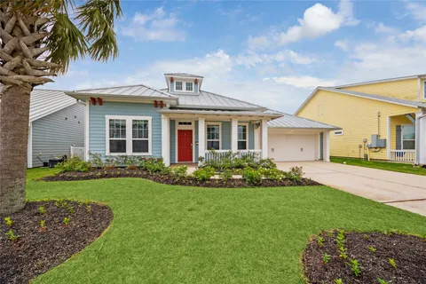 a front view of a house with a garden and yard
