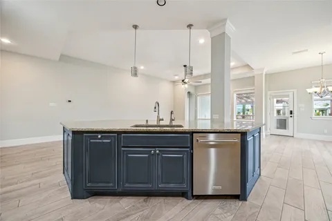 a kitchen with stainless steel appliances granite countertop a sink and wooden cabinets