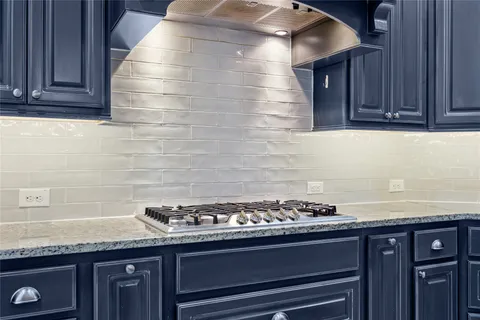a stove top oven sitting inside of a kitchen