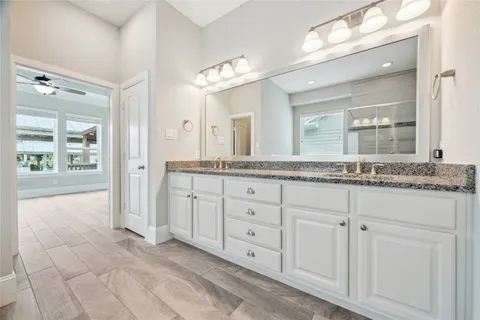 a spacious bathroom with a granite countertop sink mirror and a
