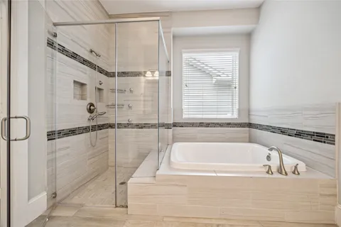 a bathroom with a tub and a shower