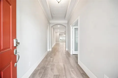 a view of a hallway with wooden floor