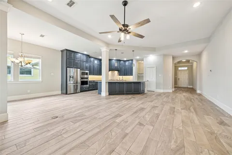a view of a kitchen with a stove and a wooden floor