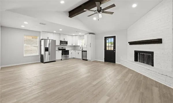 a view of a kitchen with a stove cabinets and wooden floor