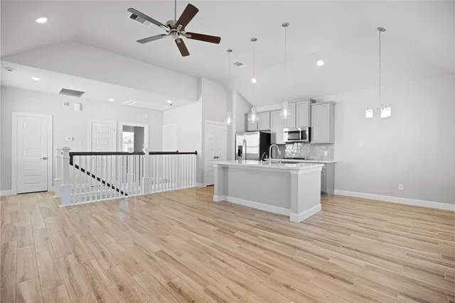 a kitchen with kitchen island a stove a sink and a microwave