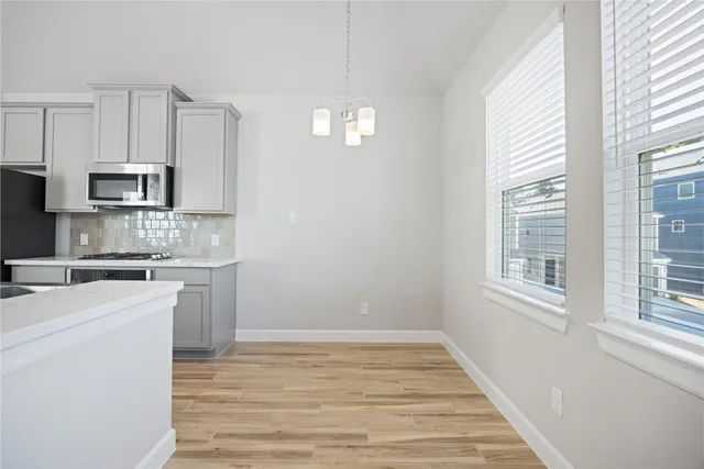 a kitchen that has a sink a stove and stainless steel appliances