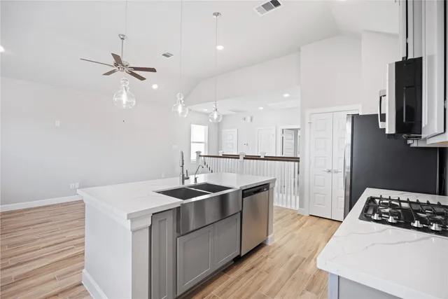 a kitchen with stainless steel appliances a refrigerator sink and microwave