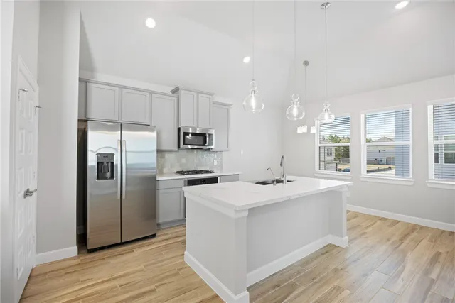 a kitchen with a sink a stove and a refrigerator