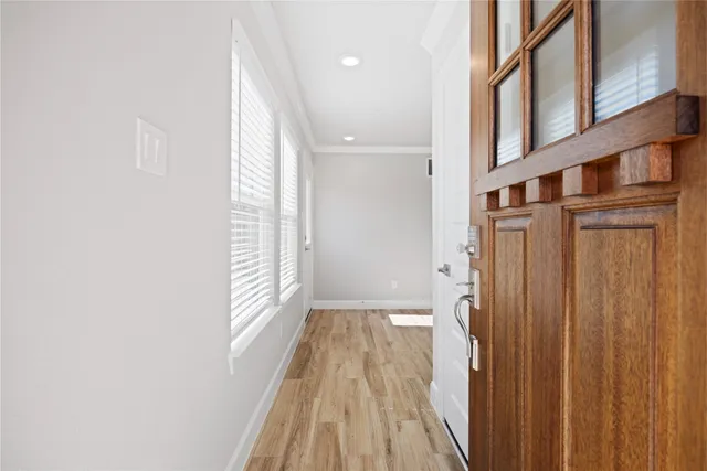 a view of entryway and hall with wooden floor