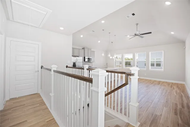 a view of kitchen with wooden floor and electronic appliances