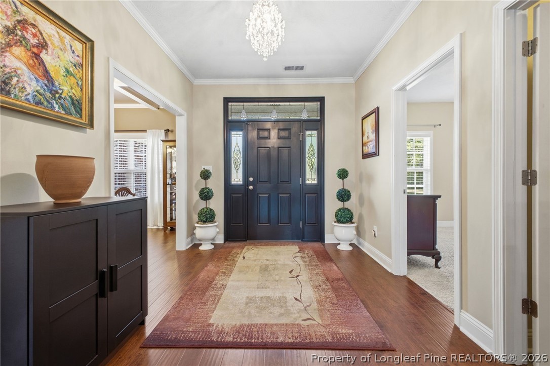 2589 June Johnson Road Raeford, NC 28376 - Photo 26 of 49 a view of a hallway with wooden floor and a livingroom