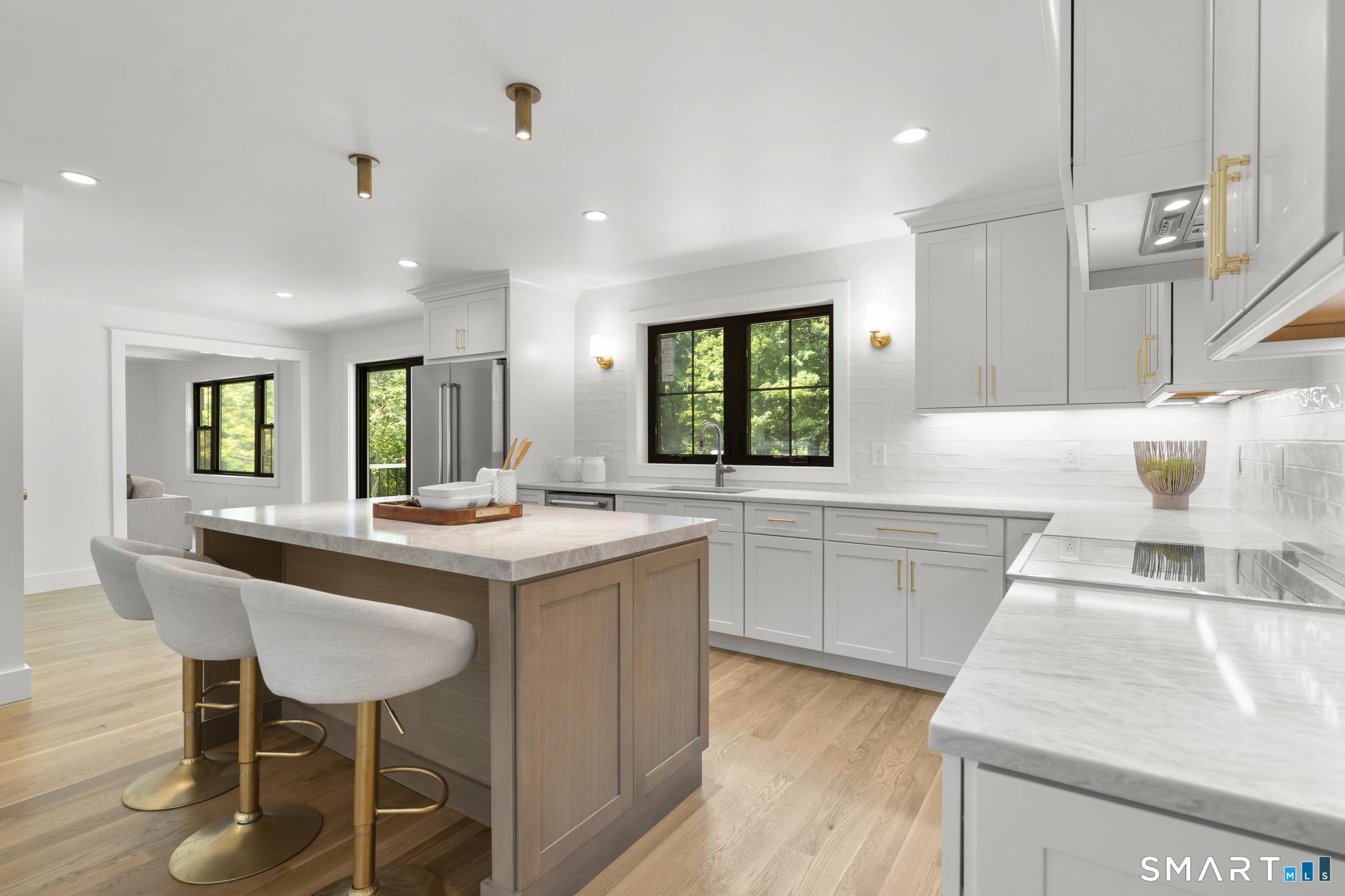 22 Beaver Brook Road Ridgefield, CT 06877 - Photo 4 of 40 a kitchen with granite countertop a sink stove and cabinets