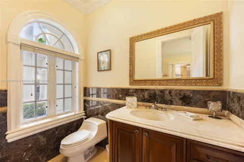 a living room with furniture a flat screen tv and a potted plant