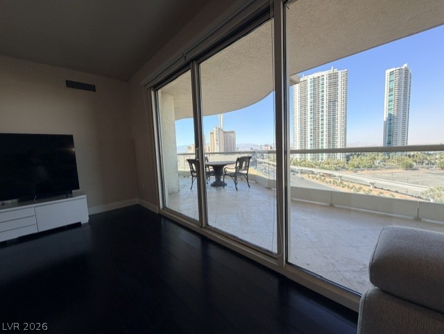 2777 Paradise Road, Unit 807 Las Vegas, NV 89109 - Photo 47 of 61 City views await from this unit, featuring a large glass balcony and dark hardwood floors.