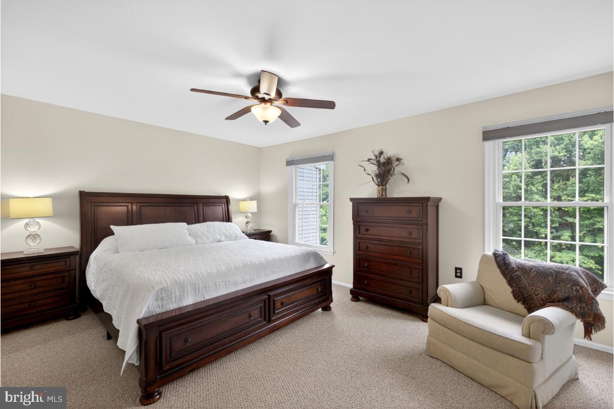 7347 Swan Point Way, Unit 122 Columbia, MD 21045 - Photo 25 of 54 a spacious bedroom with a bed and a couch