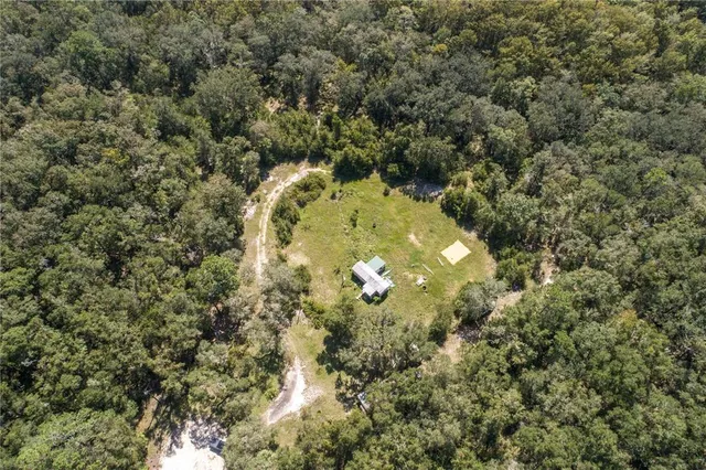 a view of a house with pool and chairs