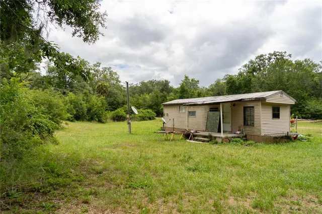 a view of a field of grass and trees