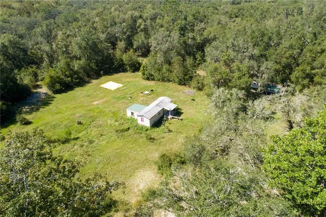 an aerial view of a house with a yard