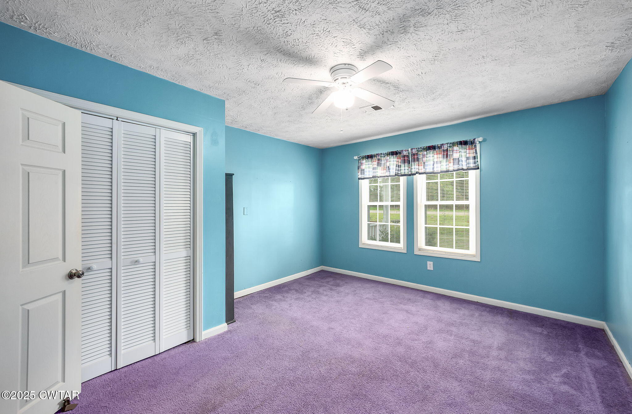598 Old Bells Road Jackson, TN 38305 - Photo 26 of 40 an empty room with chandelier fan and windows