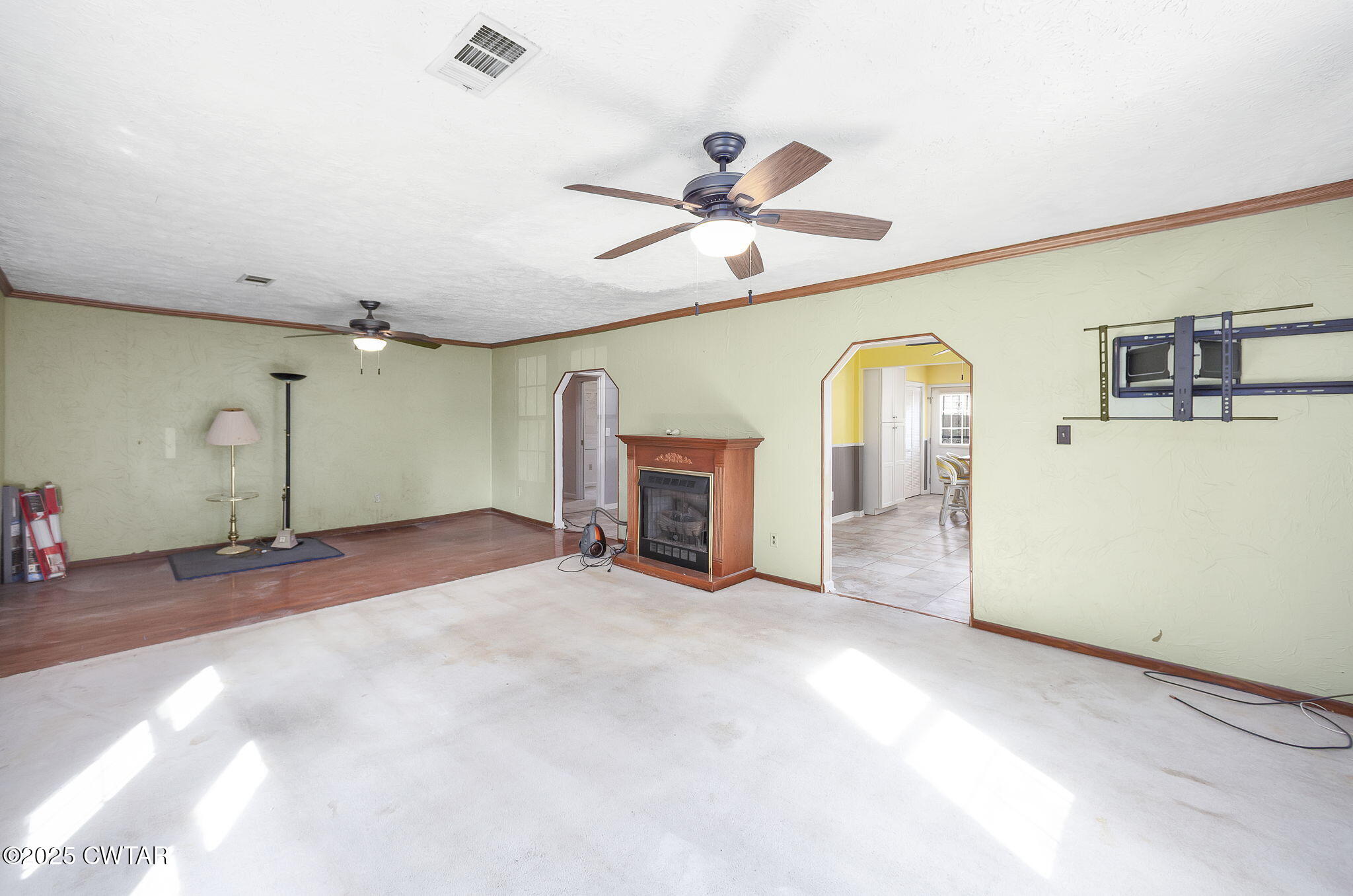 598 Old Bells Road Jackson, TN 38305 - Photo 5 of 40 a view of a livingroom with a fireplace and a ceiling fan