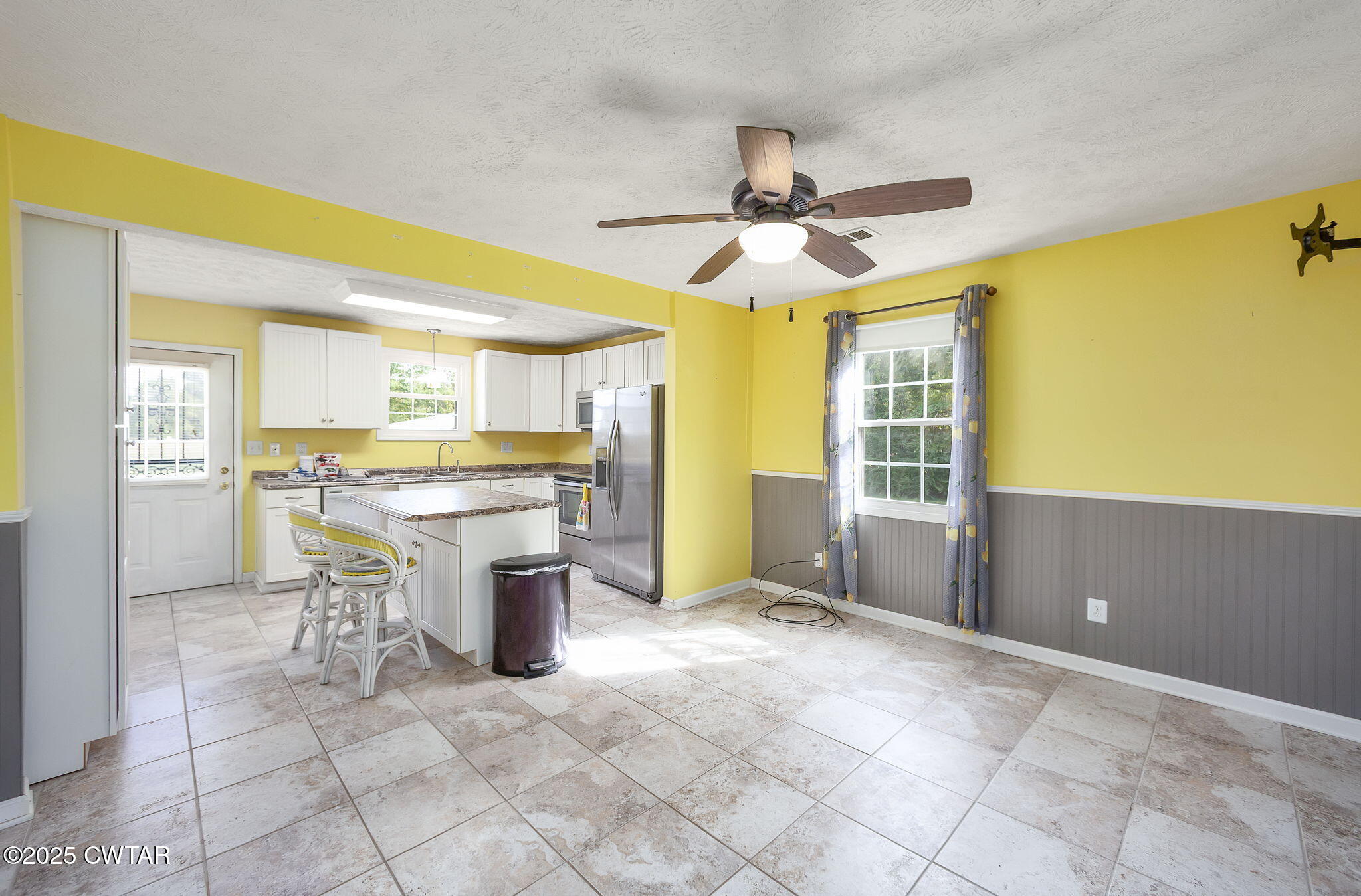 598 Old Bells Road Jackson, TN 38305 - Photo 8 of 40 a view of a kitchen with furniture and a ceiling fan