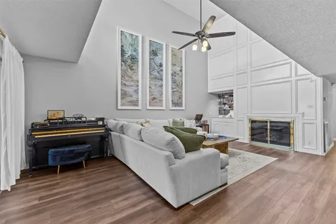 a living room with furniture a fireplace and a piano